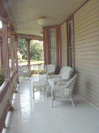 porch with chairs at the courthouse inn bed and breakfast